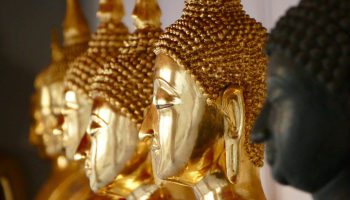 A Row Of Statues Of Buddhas