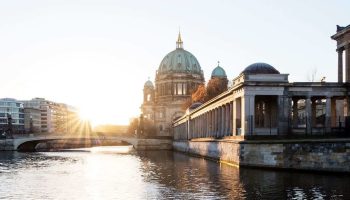 A Building With A Dome And A Bridge Over Water