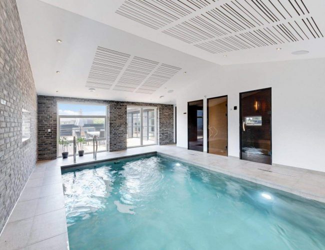 A Indoor Pool With Brick Walls And A Brick Wall