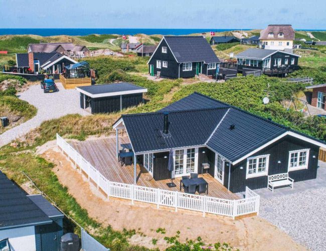 A Group Of Houses In A Grassy Area